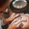 Beautician applying extended eyelashes to model at the beauty salon.